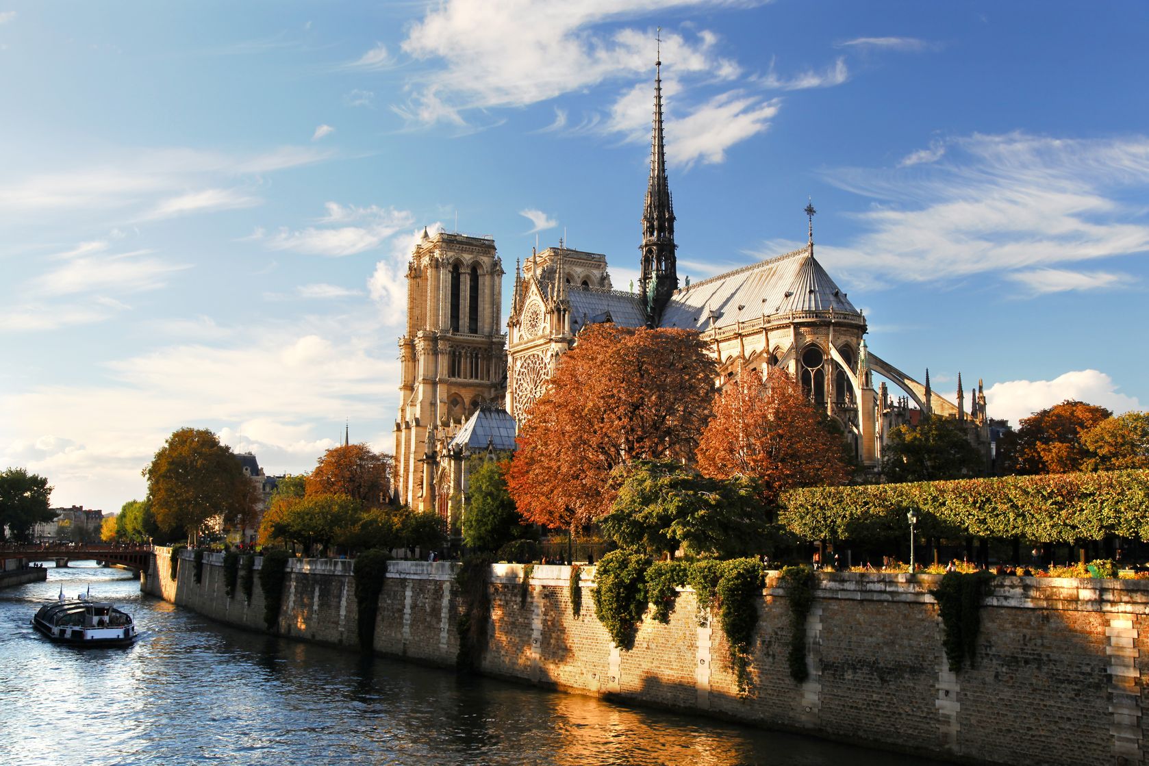 15976514 - notre dame with boat on seine in paris, france
