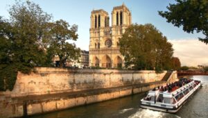 20923786 - notre dame with boat on seine in paris, france